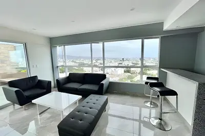 a living room with two couches and a table at Modern Apartment between Miraflores & Surquillo in Lima