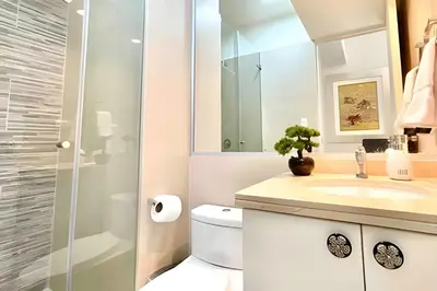 a bathroom with a toilet and a sink and a shower at Modern Apartment between Miraflores & Surquillo in Lima