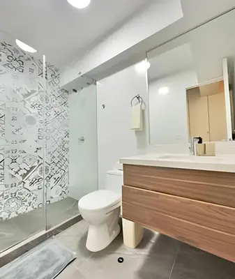 a bathroom with a toilet and a shower and a sink at Torre Platinium in Lima