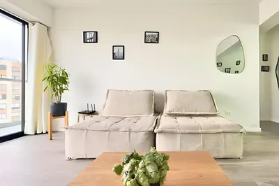 a living room with a bed and a table at Torre Platinium in Lima