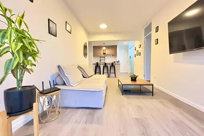 a living room with a white couch and a table at Torre Platinium in Lima