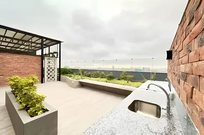 a roof deck with a view of the ocean at Torre Platinium in Lima