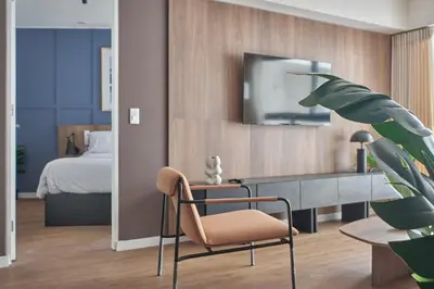 a bedroom with a bed and a desk and a chair at Celestra by Geko in Lima