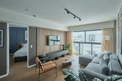 a living room with a couch and a bed at Celestra by Geko in Lima