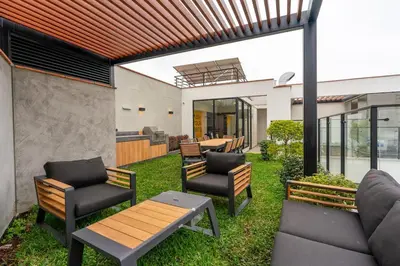 a patio with two chairs and a table and benches at Celestra by Geko in Lima