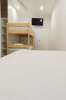 a room with a bunk bed and a television at Mystic Paracas Hotel & Glampings in Paracas