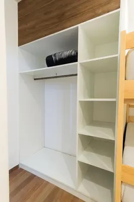 a closet with white shelves and a ladder at Mystic Paracas Hotel & Glampings in Paracas