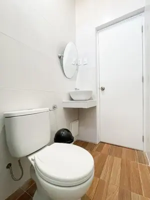 a white bathroom with a toilet and a mirror at Mystic Paracas Hotel & Glampings in Paracas