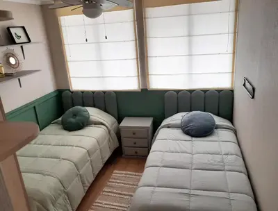 two beds in a room with two windows at Cozy 2BR, Prime Barranco, 7th Flr in Lima