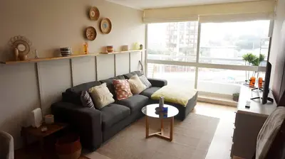 a living room with a couch and a large window at Cozy 2BR, Prime Barranco, 7th Flr in Lima