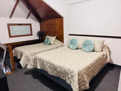 a hotel room with two beds and a mirror at Monterrico Polo Apart 4 - Frente Embajada USA in Lima