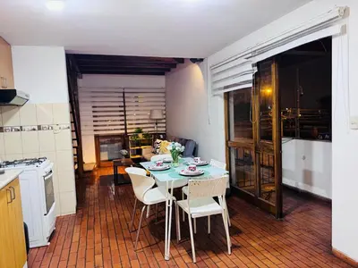 a kitchen with a table and chairs in a kitchen at Monterrico Polo Apart 4 - Frente Embajada USA in Lima