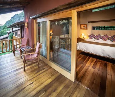 a bedroom with a bed and a balcony at Dreamy cabins in Urubamba