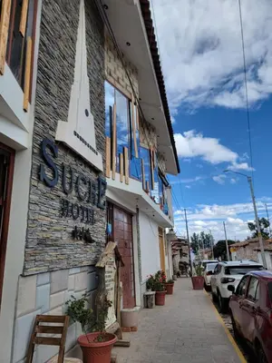 a building with a sign on the side of it at Hotel Sucre in Quinua