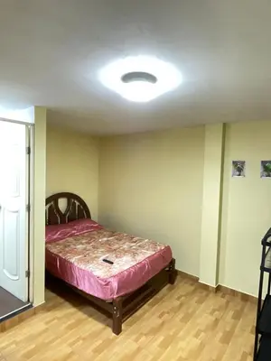 a bedroom with a bed in the middle of a room at Habitacion privada cerca al aeropuerto in Lima