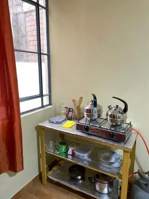 a kitchen with two pots and pans on a stove at Habitacion privada cerca al aeropuerto in Lima