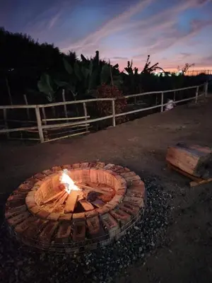 a fire pit in the middle of a yard at Casa de Campo La Martina con piscina y parrilla in Tambo de Mora