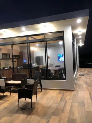 a room with a table and chairs and a large window at Casa de Campo La Martina con piscina y parrilla in Tambo de Mora