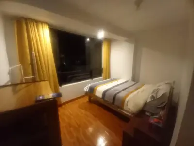a small bedroom with a bed and a window at Habitación en Cusco in Cusco