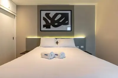 a bedroom with a bed with two towels on it at Lumiere 1BR by Geko in Lima