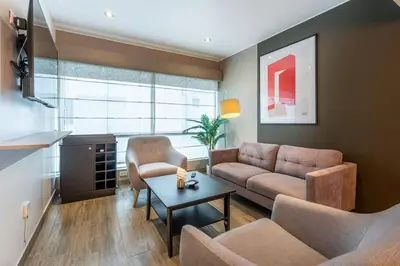 a living room with a couch and a table at Lumiere 1BR by Geko in Lima