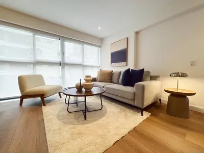 a living room with a couch and a table at New 2D with Pool-Coworking-Gym in Miraflores in Lima
