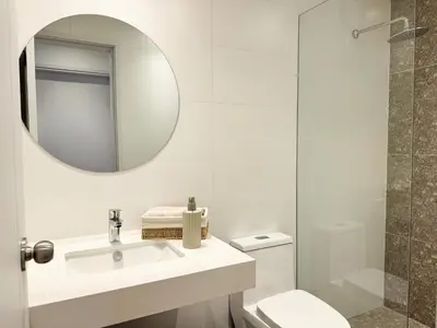 a white bathroom with a sink and a mirror at New 2D with Pool-Coworking-Gym in Miraflores in Lima