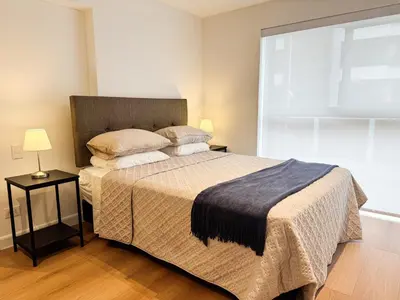 a bedroom with a large bed and a large window at New 2D with Pool-Coworking-Gym in Miraflores in Lima