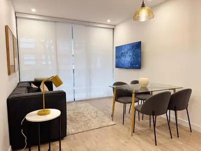 a living room with a glass table and a couch at New 2D gym-grill Miraflores 1 block Malecón in Lima