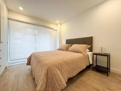 a bedroom with a large bed and a window at New 2D gym-grill Miraflores 1 block Malecón in Lima