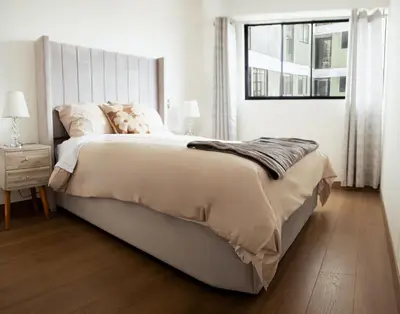a white bedroom with a large bed and a window at Charming San Isidro Stay in Lima