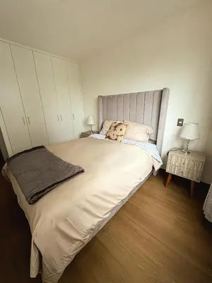 a bedroom with a large bed with a teddy bear on it at Charming San Isidro Stay in Lima