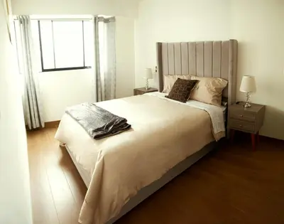 a bedroom with a large bed and a window at Charming San Isidro Stay in Lima