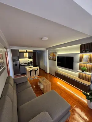 a living room with a couch and a television at Moderno Depa Céntrico en Abancay in Abancay