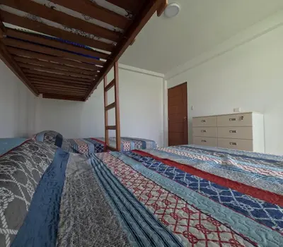 a bedroom with two beds and a dresser at Casa campo las Pecanas Huaral