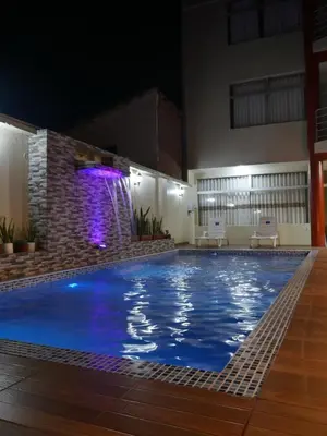 a large swimming pool with a waterfall in a building at Casa de Campo en el Valle Sagrado de los Incas - Casa Brisas del Rio Sagrado in Huayllabamba