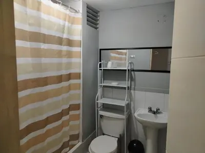 a small bathroom with a toilet and a sink at Acogedor Departamento entero en Chorrillos in Lima