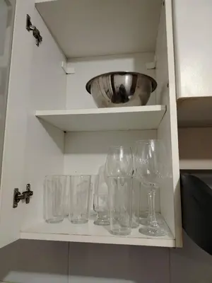 a row of wine glasses sitting on a shelf at Acogedor Departamento entero en Chorrillos in Lima