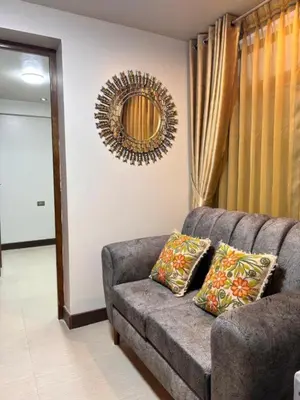 a living room with a couch and a mirror at Apartamento Lucky House Cusco in Cusco