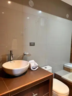 a bathroom with a bowl sink and a toilet at Apartamento Lucky House Cusco in Cusco