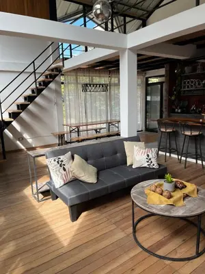 a living room with a couch and a table at Casa familiar en Oxapampa hasta 5 personas con cochera in Oxapampa