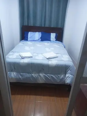 a bed with two towels on it in a bedroom at Departamento 1dormitorio 3A in Lima