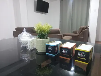 a living room with a coffee table with boxes on it at Departamento 1dormitorio 3A in Lima