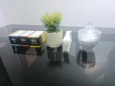 a glass table with two vases and a plant on it at Departamento 1dormitorio 3A in Lima