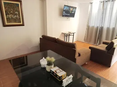 a living room with a couch and a table at Departamento 1dormitorio 3A in Lima