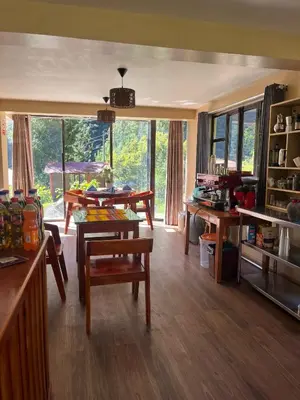 a living room with a table and chairs at TUMI Specialty Travel in Colcapampa