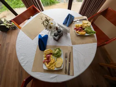 a white table with two plates of food on it at TUMI Specialty Travel in Colcapampa