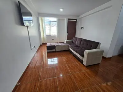 a living room with a couch and a wooden floor at 402G Modern equipped apartment in Abancay