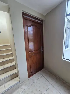 a wooden door in a room with stairs at 402G Modern equipped apartment in Abancay