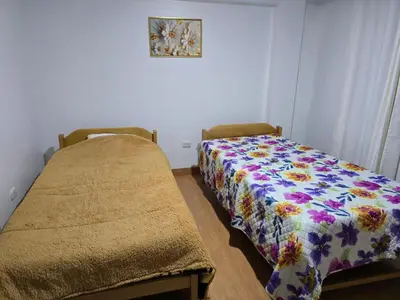two beds in a room with a blanket on it at 402G Modern equipped apartment in Abancay